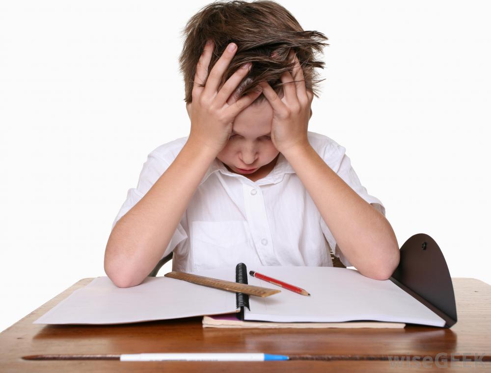 child-in-white-frustrated-while-looking-at-paper-on-desk.jpg